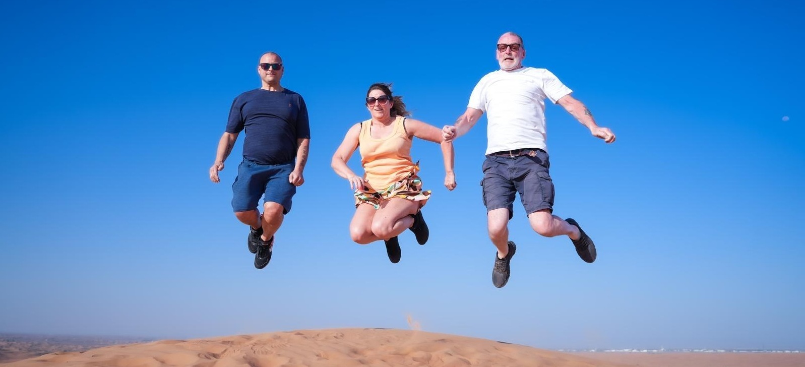 Family jumping on beach